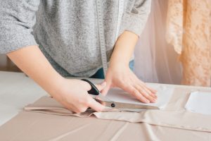 Seamstress Cutting Cloth